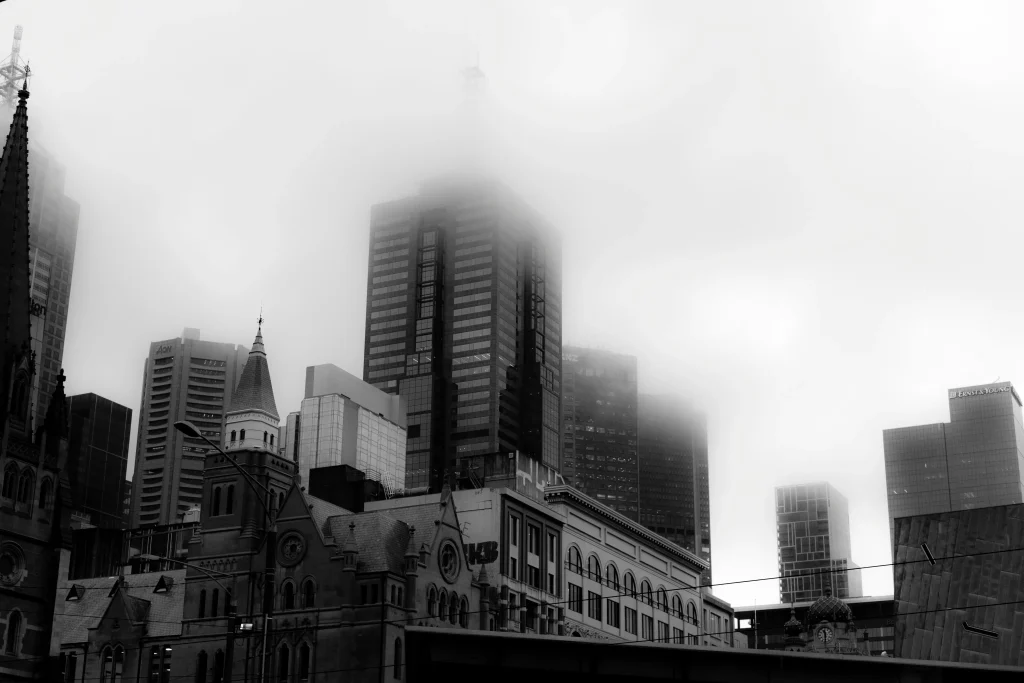 Melbourne CBD skyline shrouded in thick winter fog showing moisture and condensation that causes mould in Victorian homes